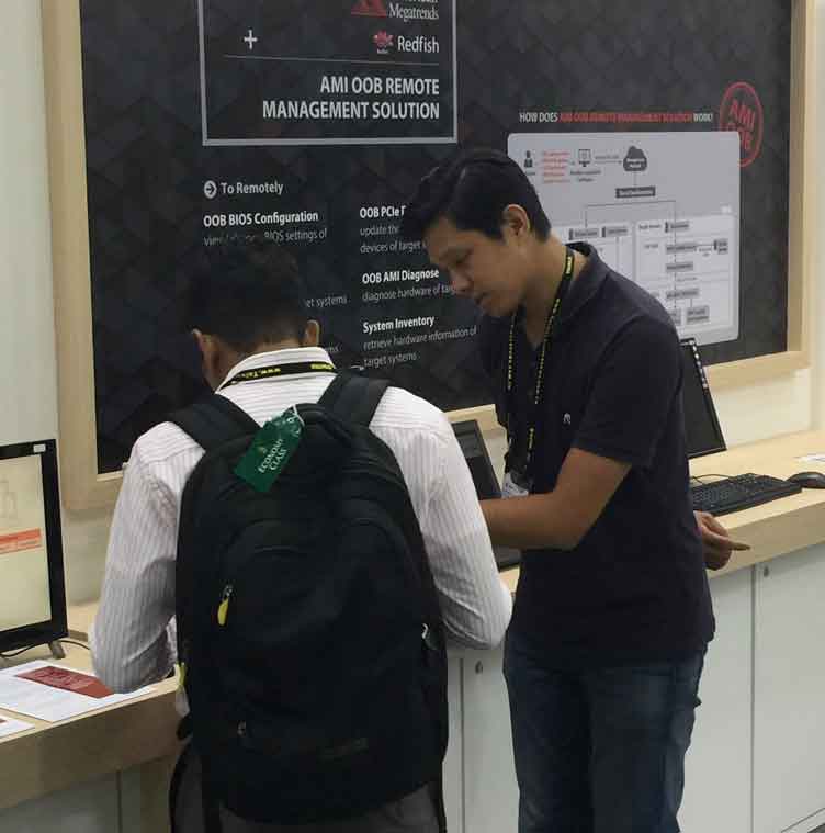 Two people interacting with AMI booth